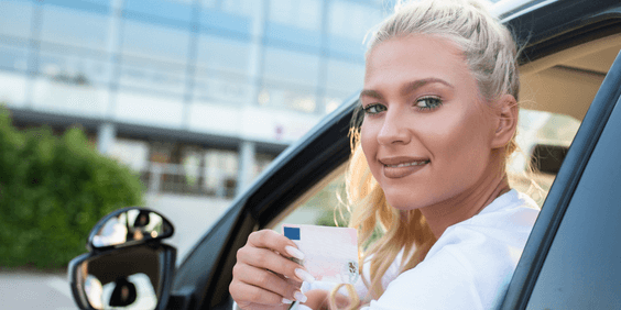 Woman holding drivers license, points on your license