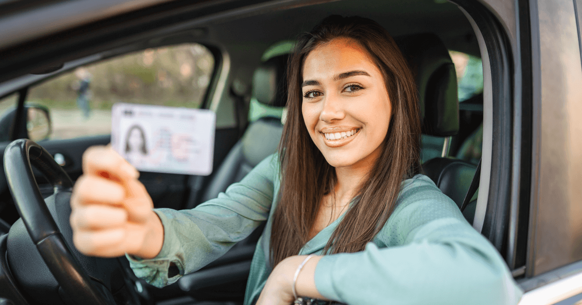Smiling woman with driver license